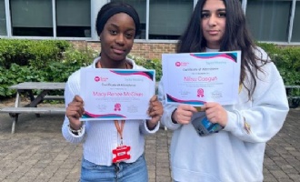 Students holding up certificates