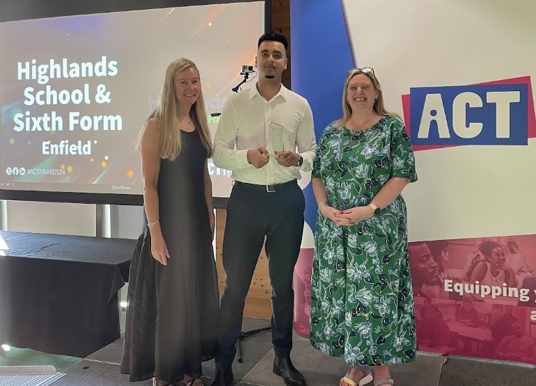 Mr Islam collecting award for secondary school of the year at ACT