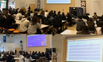 students in main hall listening to a presentation