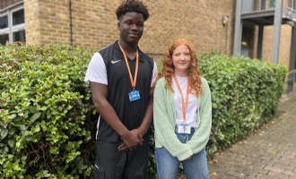 two head students standing outside school